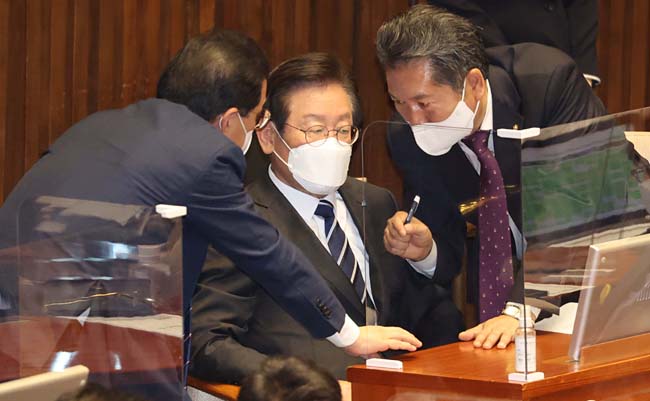 이재명 더불어민주당 대표가 7일 국회에서 열린 본회의에 참석해 박홍근(왼쪽 뒷모습) 원내대표와 정청래(오른쪽) 최고위원과 대화를 나누고 있다. 국회사진기자단