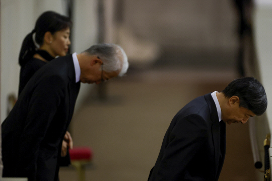 나루히토(오른쪽) 일왕이 18일(현지시간) 영국 런던의 웨스트민스터 홀에 안치된 엘리자베스 2세 영국 여왕의 관을 참배하고 있다. AFP·연합뉴스