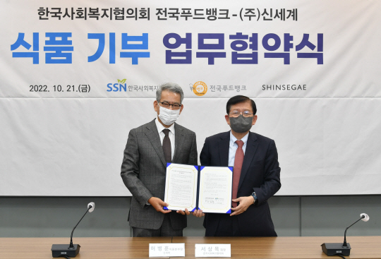 ▲허병훈(왼쪽) 신세계 지원본부장과 서상목 한국사회복지협의회장이 업무협약 후 기념촬영을 하고 있다. 한국사회복지협의회 제공