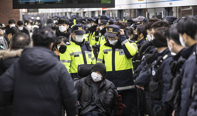 전국장애인차별철폐연대(전장연) 회원들이 2일 오전 서울 지하철 4호선 삼각지역에서 장애인 권리 예산 보장을 촉구하는 출근길 지하철 탑승 시위에서 탑승을 시도하고 있다. 뉴시스