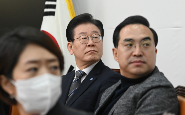 22일 오전 국회에서 열린 더불어민주당 최고위원회의에서 이재명(가운데) 대표가 김건희 여사의 도이치모터스 주가 조작 의혹 사건의 특검 필요성을 주장하는 영상을 쳐다보고 있다.  김동훈 기자