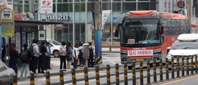 경남 창원 지역 시내버스가 파업에 돌입한 19일 오전 마산합포구 경남대·남부터미널종점 버스 정류소에 ‘임시 시내버스’라는 문구가 부착된 버스가 들어서고 있다.  연합뉴스