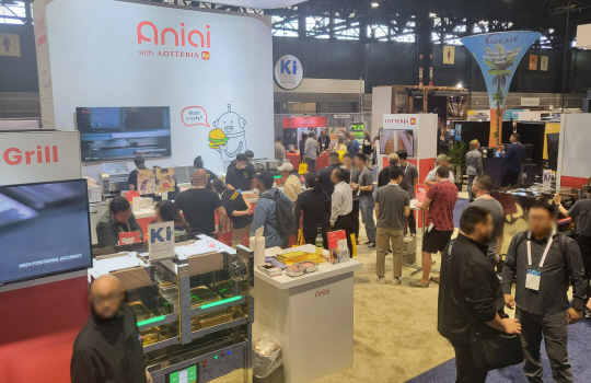 미국 시카고에서 열린 외식 산업 박람회 ‘NRA쇼’에 참여한 롯데리아와 스타트업 에니아이의 부스를 관람객들이 살펴보고 있다. 롯데GRS 제공