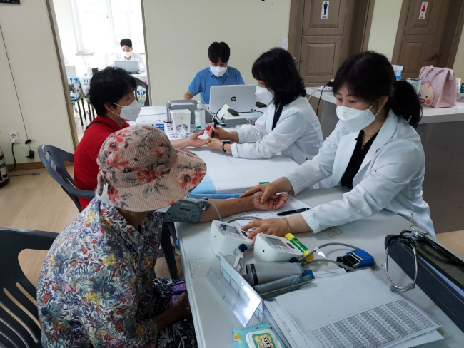 지난 8일 경북 김천시 부항면 희곡2리 마을회관에서 김천시와 충북 영동군, 전북 무주군이 공동으로 구성한 의료진이 주민들을 진료하고 있다.  김천 = 박천학 기자