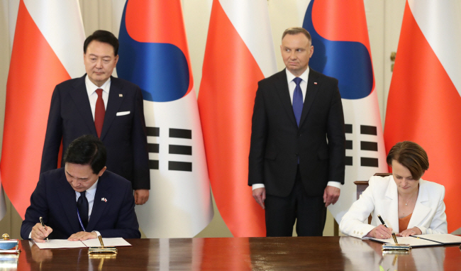 원희룡(왼쪽) 국토교통부 장관과 야드비가 에밀레비치 폴란드 우크라이나 개발협력 전권대표가 13일(현지시간) 폴란드 바르샤바 대통령궁에서 윤석열 대통령과 안제이 두다 폴란드 대통령이 지켜보는 가운데 한·폴란드 우크라이나 재건 협력 협정(MOU)에 서명하고 있다. 연합뉴스
