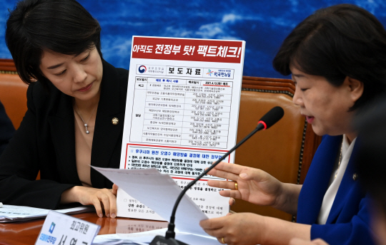 지난 14일 열린 더불어민주당 최고위원회의에서 서영교(오른쪽)최고위원이 후쿠시마 오염수 해양방류에 대한 ‘문재인정부의 오염수 해양투기 용인’과 관련한 팩트체크에서 전정부의 후쿠시만 오염수 해양방류 반대가 명시된 정부 공식문서를 제시하고 있다. 곽성호기자