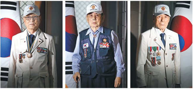 6·25전쟁 참전용사들이 서울 동작구 국립현충원에서 ‘전우’들에게 참배를 마친 뒤 태극기 앞에서 사진을 찍고 있다. 이들은 자유민주주의와 대한민국을 지키기 위해 싸웠던 6·25전쟁의 의미를 기억해 달라고 당부했다. 왼쪽부터 고융희(88), 류재식(91), 김영환(90) 참전용사. 윤성호 기자