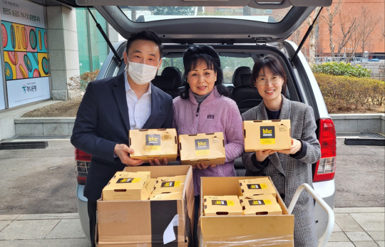 bhc치킨 가맹점, 본사 임직원들이 한 사회복지시설에 치킨을 기부하고 기념 사진을 찍고 있다. bhc치킨
