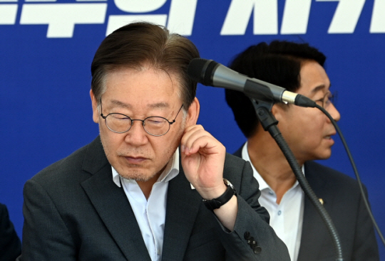 이재명(왼쪽) 더불어민주당 대표가 6일 오전 국회 본청 앞 단식천막에서 열린 최고위원회의에 참석하며 귀를 만지고 있다.박윤슬 기자