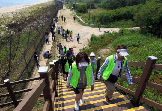 지난 2019년 4월27일 개방된 강원 고성과 인제를 연결하는 비무장지대(DMZ) 평화의 길 코스 탐방에 나선 방문객들이 2019년 6월26일 동해안 철책을 따라 걷고 있다. 연합뉴스