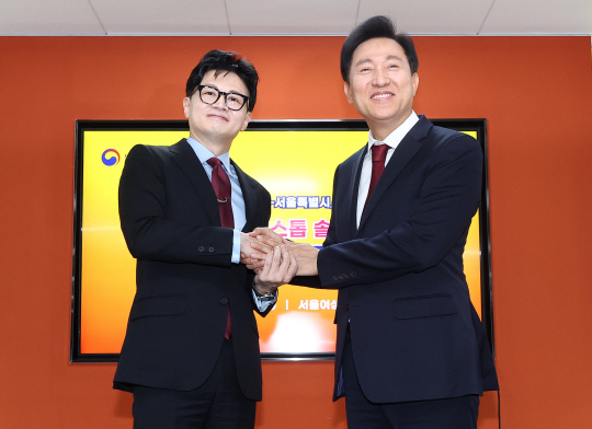 한동훈(왼쪽) 법무부 장관과 오세훈 서울시장이 15일 오후 서울 동작구 서울여성플라자에서 열린 법무부-서울시 범죄피해자 원스톱 솔루션 센터 설치·운영 업무협약식에서 협약서에 서명한 뒤 악수를 나누고 있다. 연합뉴스