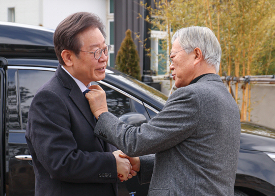 이재명 더불어민주당 대표가 지난 4일 경남 양산시 평산마을 문재인 전 대통령 사저를 찾아 문 전 대통령과 인사 나누며 피습당한 목의 흔적과 관련한 대화를 나누고 있다. 더불어민주당 제공