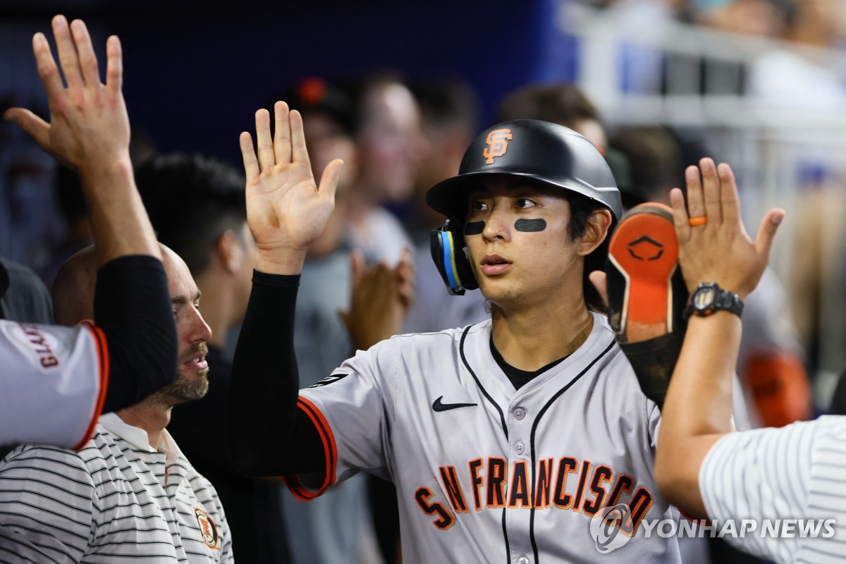 득점에 성공하고 팀 동료와 인사하는 이정후[게티이미지/AFP=연합뉴스]