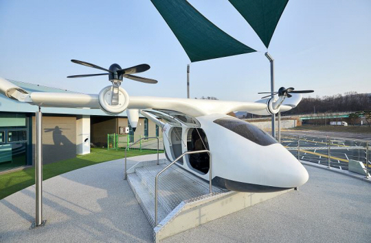 드론 UAM(Urban Air Mobility) 실물 모형 + VR(Virtual Reality) 체험: 실물 모형의 UAM에 탑승하여 드론으로 촬영한 남한강 영상을 VR로 감상, 드론 내부 의자는 시뮬레이터처럼 화면의 영상을 따라 움직여 실감을 더해 줌. 한국도로공사 제공