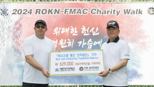 11일 서울 마포구 서울함공원에서 실시한 주한외국무관단 주관 바다사랑 해군장학재단 기부행사에서 주한 외국무관단장 로드리고 페레스(왼쪽)가 강동길(오른쪽) 해군참모차장에게 제2연평해전 승전일 6월29일을 기념해 62만 9000원을 바다사랑 해군 장학재단에 기부한 뒤 기념촬영하고 있다. 해군 제공