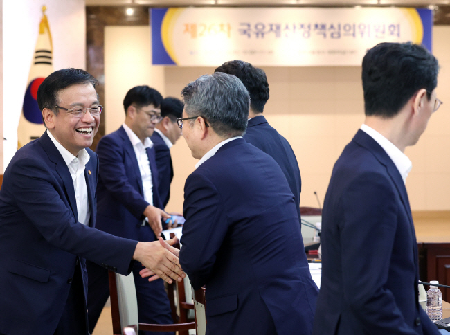 최상목(왼쪽) 부총리 겸 기획재정부 장관이 14일 오전 정부서울청사에서 열린 국유재산정책심의위원회에서 참석자들과 인사를 나누고 있다.  연합뉴스