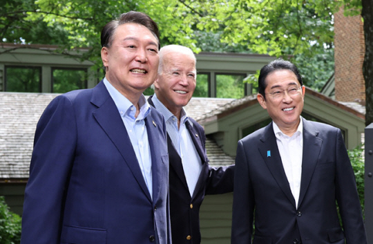 지난 2023년 8월 18일(현지시간) 윤 대통령과 바이든 미 대통령, 기시다 일본 총리가 워싱턴DC 인근 미국 대통령 별장인 캠프 데이비드에서 열린 한미일 정상회의를 앞두고 로렐 로지 앞에서 기념 촬영하는 모습. 연합뉴스 자료사진