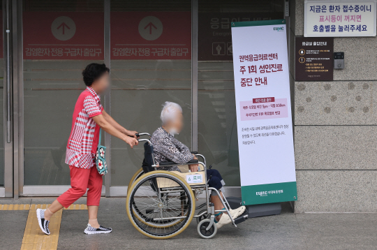 응급실 의료대란이 이어진 13일 오전 서울 시내 한 대학병원 권역응급의료센터 앞에 주1회 진료 중단 안내 배너가 설치돼 있다. 연합뉴스