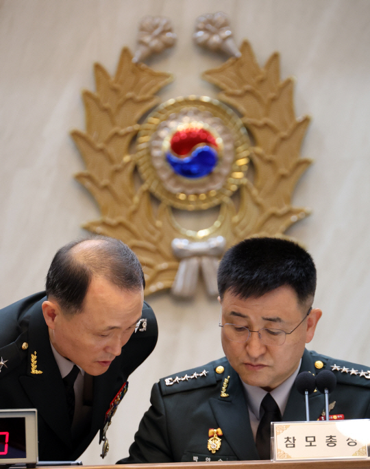 17일 충남 계룡대에서 열린 국회 국방위원회의 육군본부에 대한 국정감사에서 박안수(오른쪽) 육군참모총장이 문홍식(왼쪽) 육군공보정훈실장과 답변내용을 논의하고 있다. 뉴시스 제공