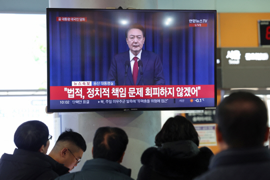 윤석열 대통령 탄핵소추안 표결이 예정된 7일 오전 광주 서구 종합버스터미널 대합실에서 시민들이 윤 대통령 대국민 담화를 보고 있다. 연합뉴스