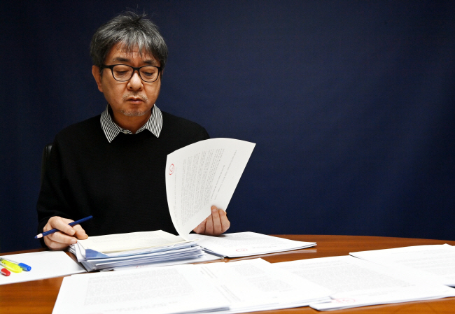 2025 문화일보 신춘문예 문학평론부문 심사를 맡은 김형중 평론가가 응모작을 살펴보고 있다. 윤성호 기자