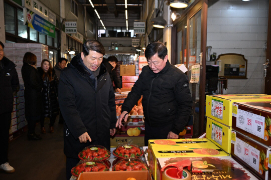 백경현(왼쪽) 구리시장이 설 명절을 앞두고 22일 구리농수산물도매시장을 찾아 장을 보며 상인과 얘기를 나누고 있다. 구리시 제공