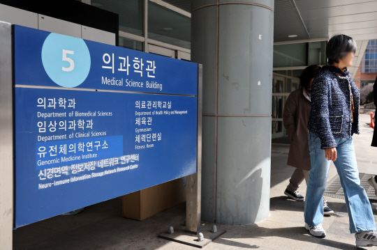 서울대 의과대학 학장단이 의대생들에 오는 27일을 마지노선으로 제사하며 복귀를 호소한 가운데 서울대 의대 건물 앞에 사람들이 지나다니고 있다. 연합뉴스